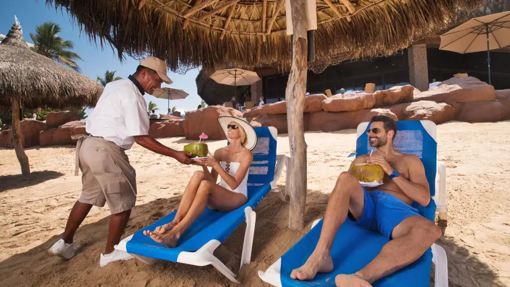 El Cid El Moro Beach Hotel_couple on beach lounging enjoying drink