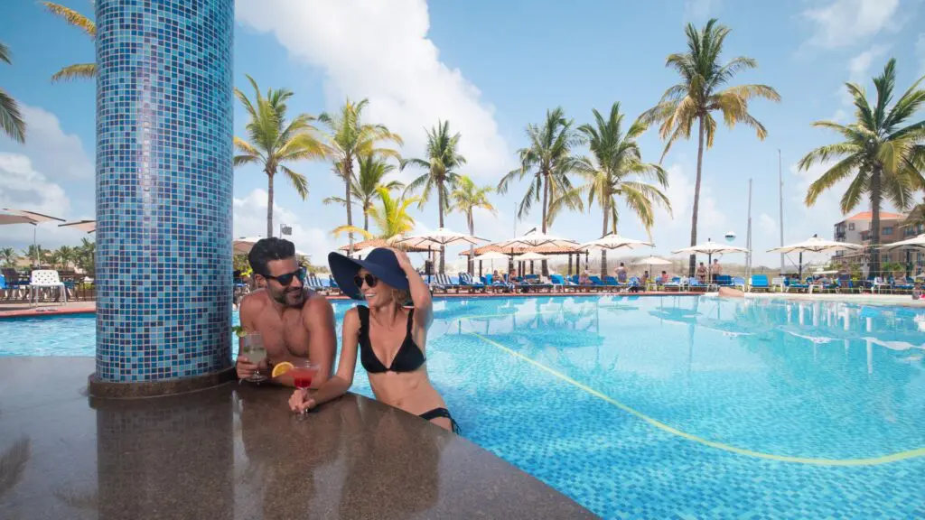 El Cid Marina Beach Hotel_couple having drink by pool bar