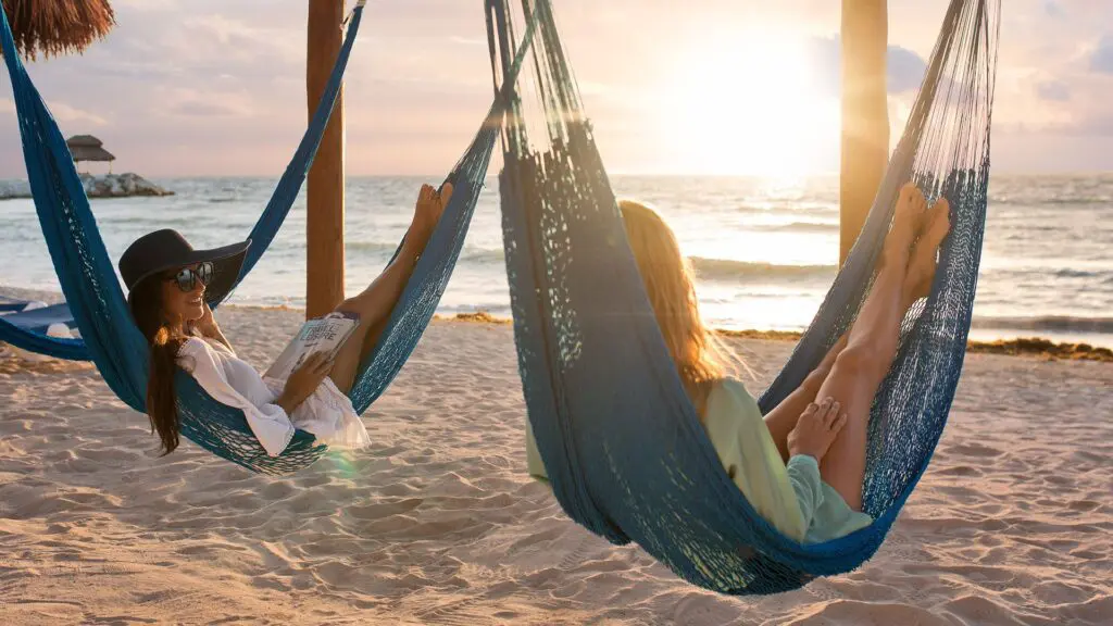 Hotel Marina El Cid Spa & Beach Resort_ladies laying in hammocks on beach