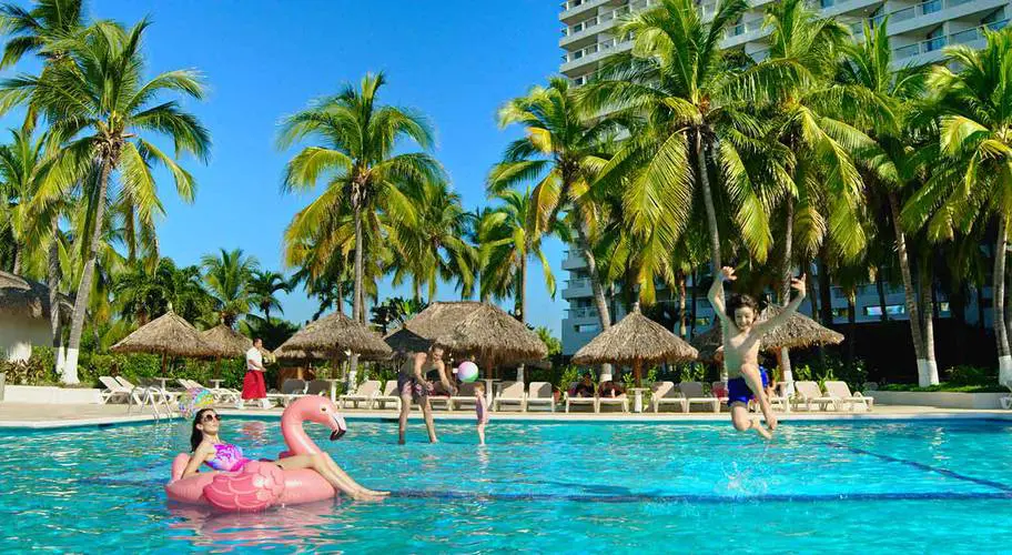 Park Royal Beach Ixtapa_lady floating on pink flamingo in pool