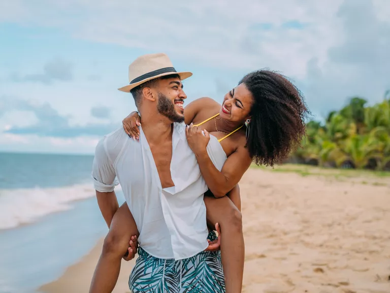 couple on honeymoon walking on beach